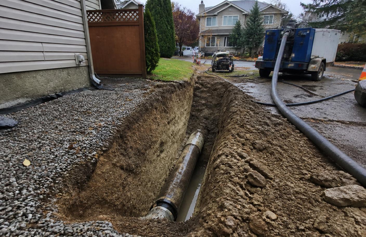 Excavated trench exposing an underground sewer pipe at a Canadian home